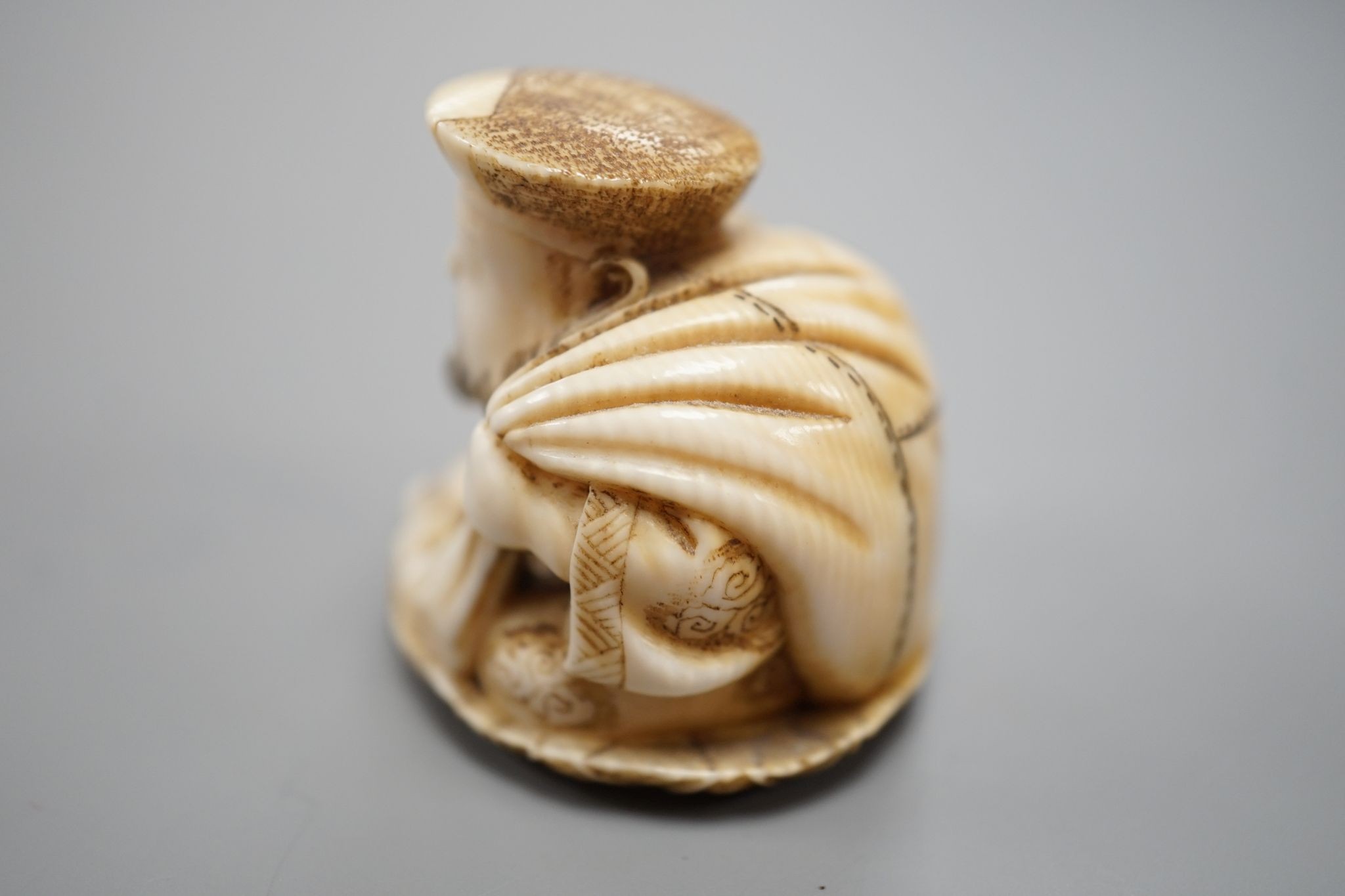 A Japanese ivory netsuke of Daikoku, Meiji period, 3 cms high.